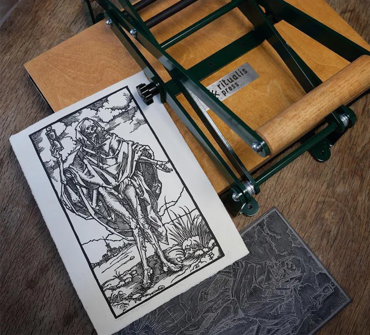 Printed papers with wooden linocut printing press by Ritualis Press.